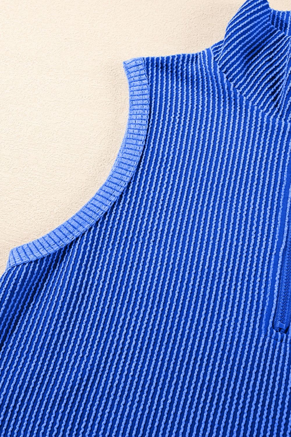 Royal blue ribbed knit polo shirt with quarter zip and textured vertical stripes.