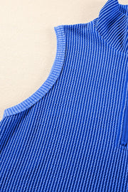 Royal blue ribbed knit polo shirt with quarter zip and textured vertical stripes.