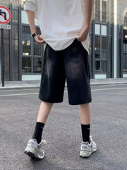 Black relaxed fit distressed denim shorts for men with a baggy cut.