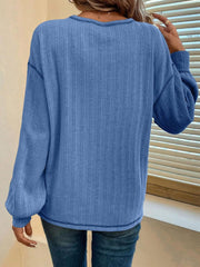 Blue ribbed knit sweater with contrast stitching and crew neck.