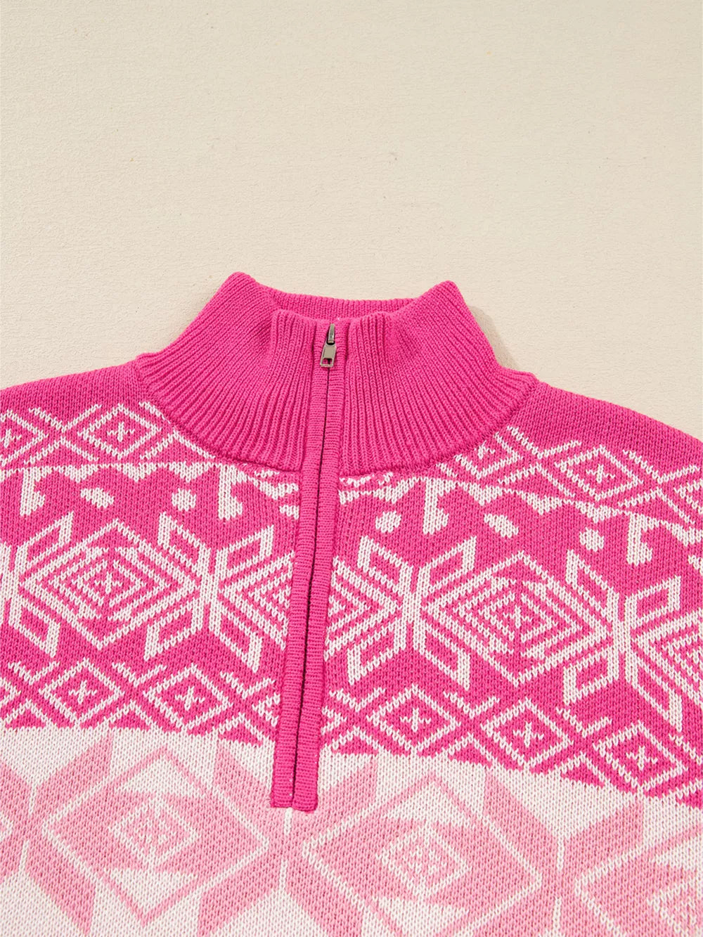 Festive Fair Isle quarter zip knit top in pink with a geometric pattern.