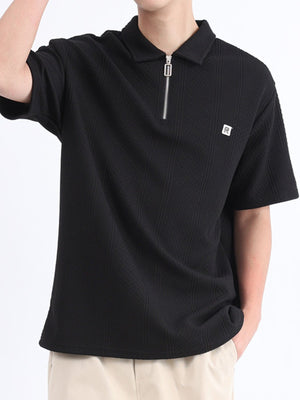 Black textured polo shirt with short sleeves and a zipper detail