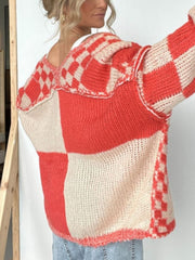 Oversized checkerboard knit cardigan in deep red and cream with a relaxed fit and open front.