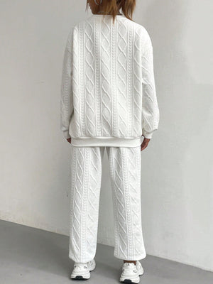 White cable knit loungewear set with crewneck sweatshirt and wide leg pants.