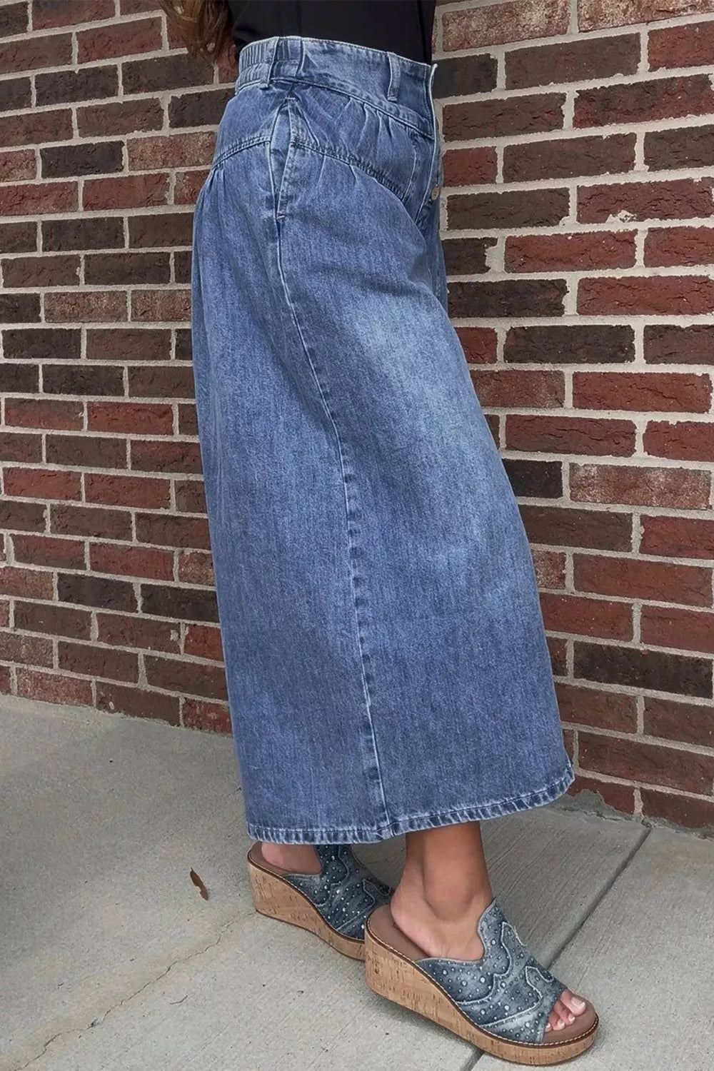 Denim maternity jeans with a high waist and wide leg, ankle length, button fly, and pockets.