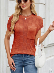 Textured knit t-shirt in rust orange with short sleeves and a chest pocket.