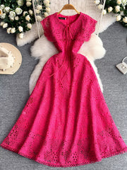 Fuchsia pink lace A-line dress with tie detail and cap sleeves.