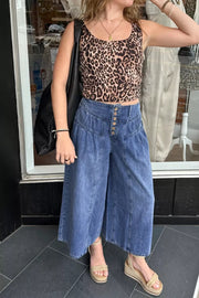 Elevated High-waisted Wide-leg Jeans in blue denim with button fly and ankle length.