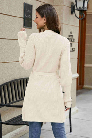 Cream knit cardigan with puffed sleeves and a matching belt, casual long sleeve sweater