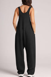 Black relaxed fit pocketed jumpsuit with wide legs and scoop neck.