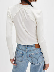 White 100% cotton cropped cardigan with cable knit panels and ribbed long sleeves.
