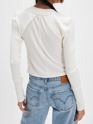 White 100% cotton cropped cardigan with cable knit panels and ribbed long sleeves.