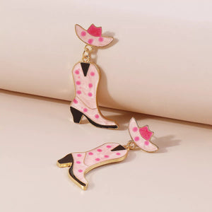 Pink cowboy boot dangle earrings with polka dots and a hat charm.