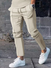 Casual drawstring sweatpants in apricot with pockets and stitched seams.