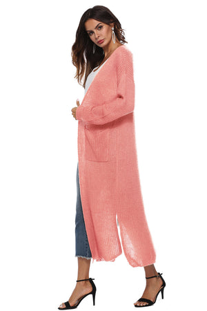 Coral longline knit cardigan with side slits and pockets.