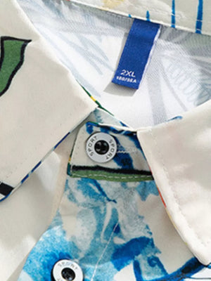 Tropical print oversized button-up shirt in white with blue floral pattern and button details.