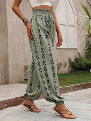 Sage ankle trousers with black leaf print, gathered waist and cuffs.