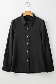 Black textured ribbed button-down shirt with a collared neckline and long sleeves.