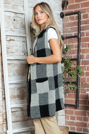 Geometric knit duster vest in black and tan checkered pattern, sleeveless, with pockets.