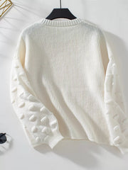 Ivory knit sweater with textured dot sleeves and crew neck.