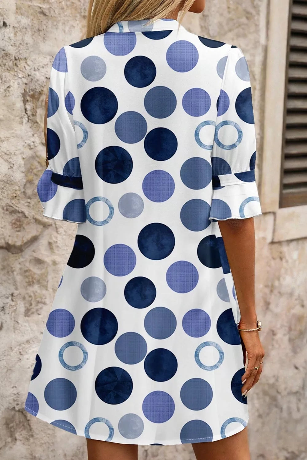 Chic blue polka dot mini dress with flounce sleeves and a-line cut.