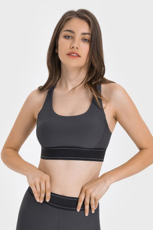 Gray performance sports bra with crossback straps and black band detail