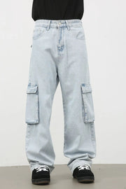 Oversized light wash denim cargo pants with large side pockets and a relaxed fit.