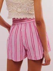Pink striped shorts with elastic waistband and crochet top styling.