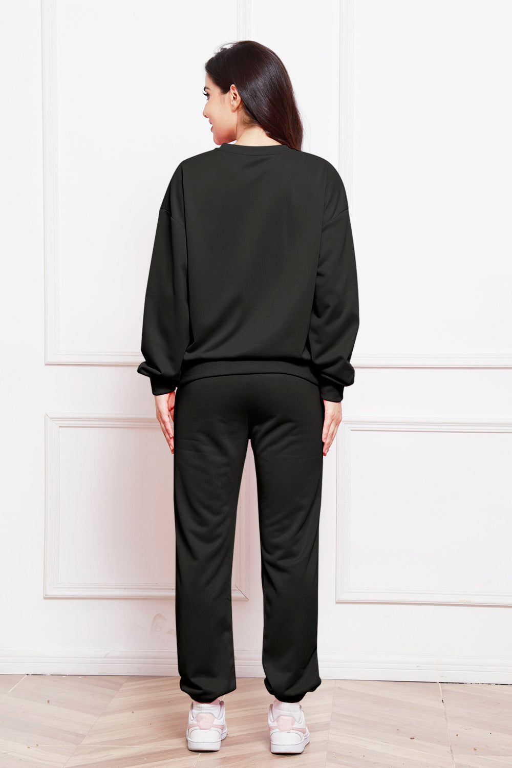 Black relaxed fit loungewear set with crewneck sweatshirt and sweatpants.