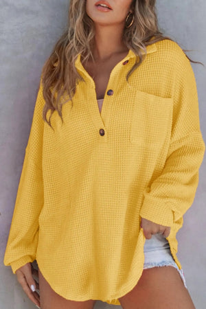 Waffle knit henley shirt in gold with button neckline and chest pocket.