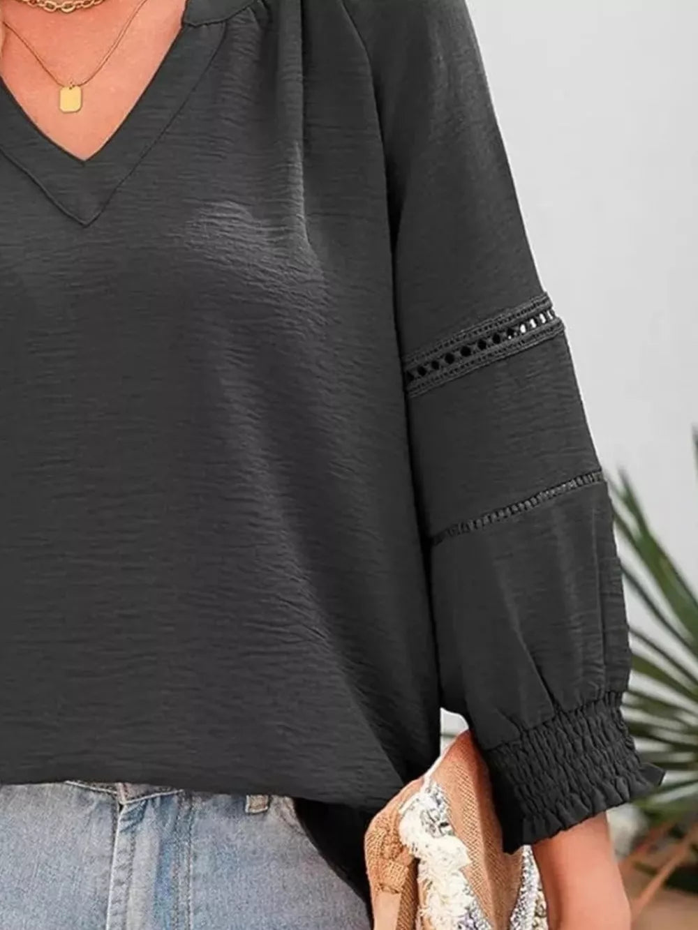 Gray green long sleeve blouse with smocked cuffs and lace trim detail