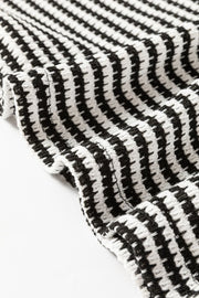 Textured stripe balloon sleeve top in black and white houndstooth pattern.