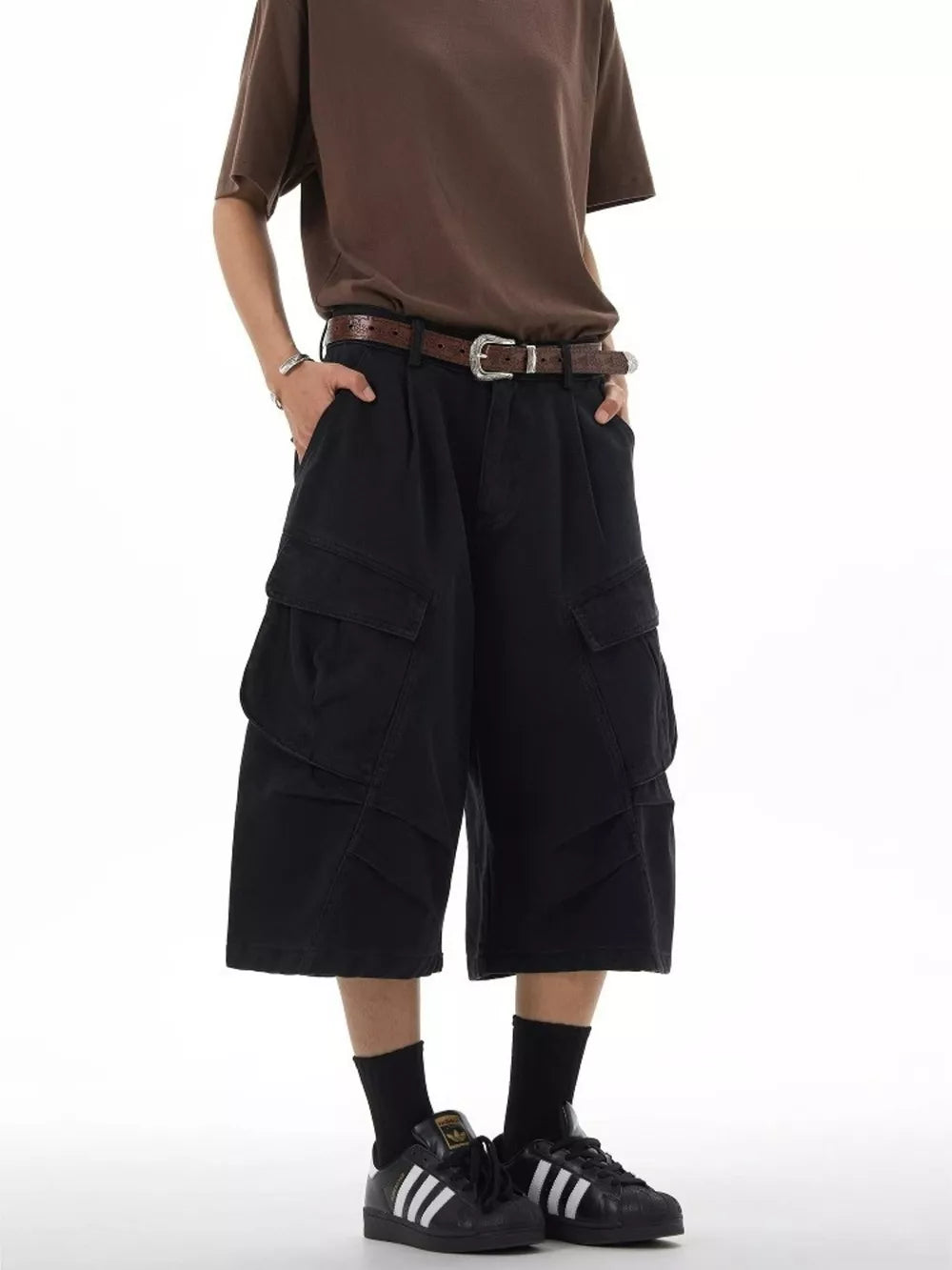 Black relaxed fit cargo capris with multiple pockets and a brown belt.