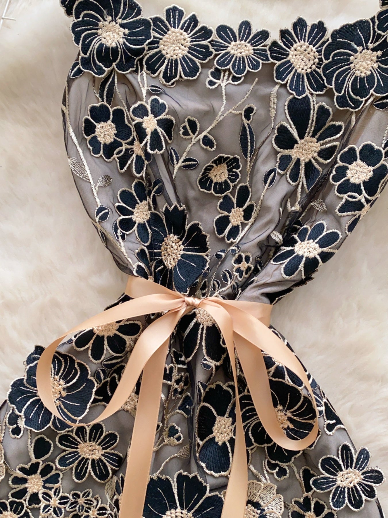 Embroidered floral mini dress in black gold with a satin bow detail.