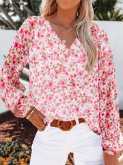 Pink floral print V-neck maternity shirt with long sleeves.