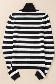 Graphic ribbed turtleneck top in black and white stripes with long sleeves.