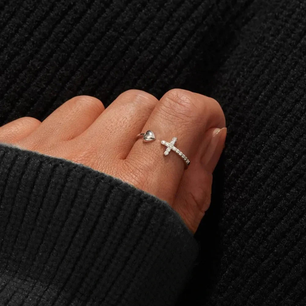 Open heart and cross ring with zirconia details in silver.