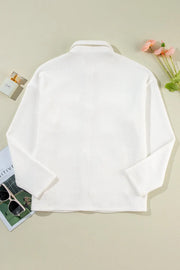 White textured corduroy overshirt with a collar and long sleeves.