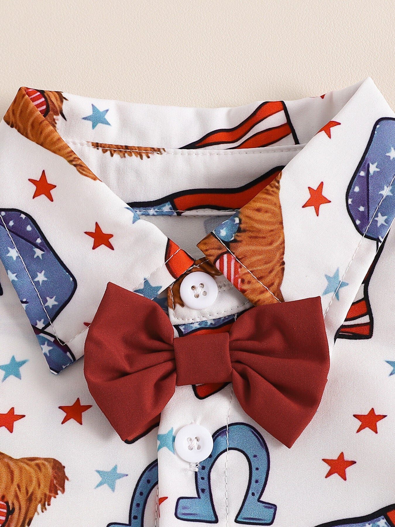 Toddler patriotic print shirt with attached red bow tie and white buttons.
