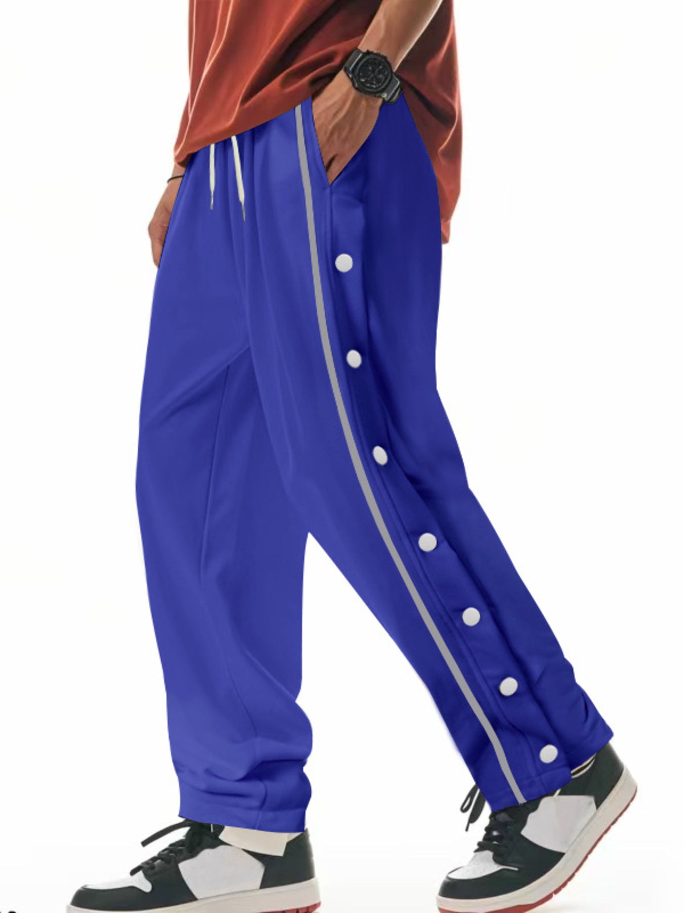 Royal blue track pants with side snap buttons and grey stripe detail.