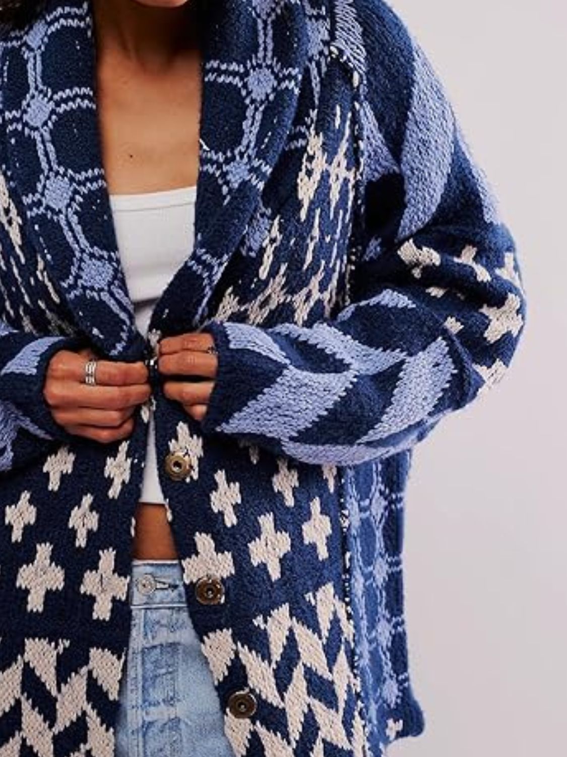 Dusty blue geometric patchwork knit cardigan with shawl collar and button front.