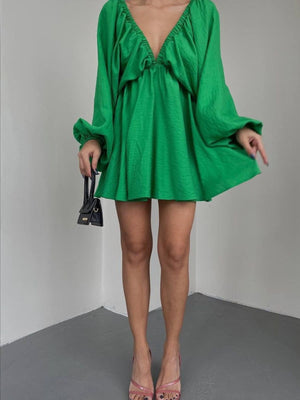 Green ruched V-neck dress with balloon sleeves and a mini hem.