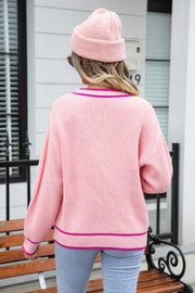 Pink acrylic cardigan with contrast trim and pockets, shown from the back.
