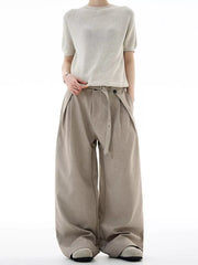 Tailored plus size wide-leg sweatpants in khaki with a belted waist and pleats.
