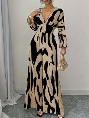 Abstract print wide leg jumpsuit with V-neck and long sleeves in beige and black.