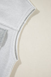 Light gray cotton utility vest detail showing contrast trim and stitching.
