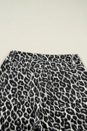 Chic cropped leopard print denim jeans with back pockets and adjustable waist detail.