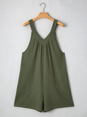 Moss green textured romper with V-neck, gathered yoke, and rounded pockets.