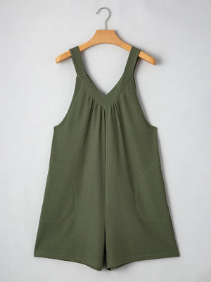 Moss green textured romper with V-neck, gathered yoke, and rounded pockets.