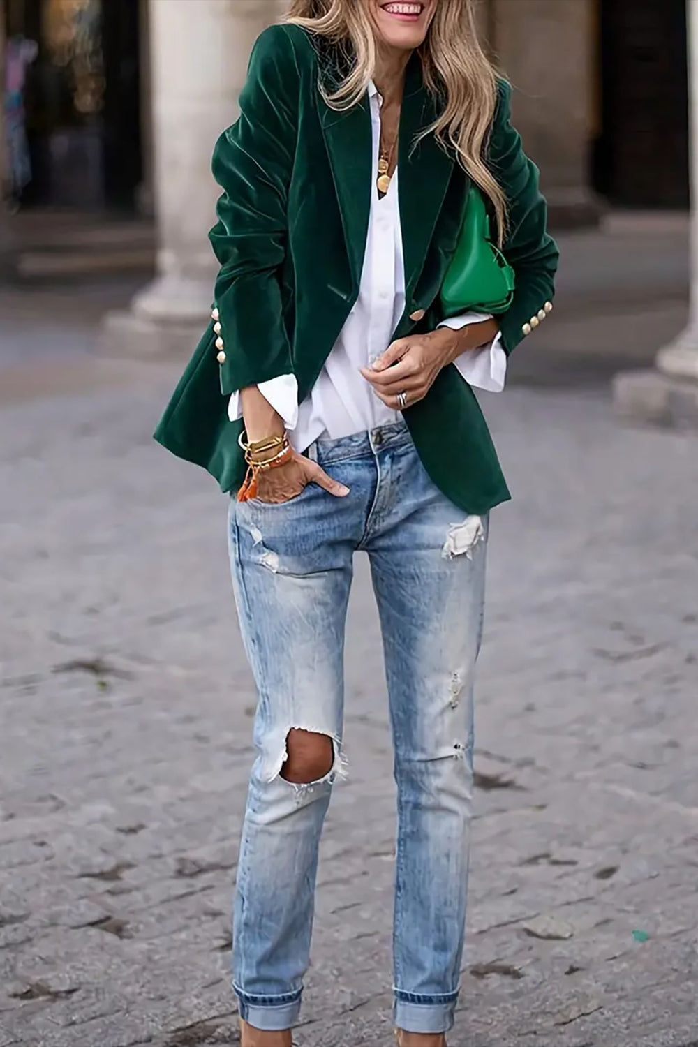 Velvet blazer in Black Forest with gold button detail, styled with a white shirt and ripped jeans.